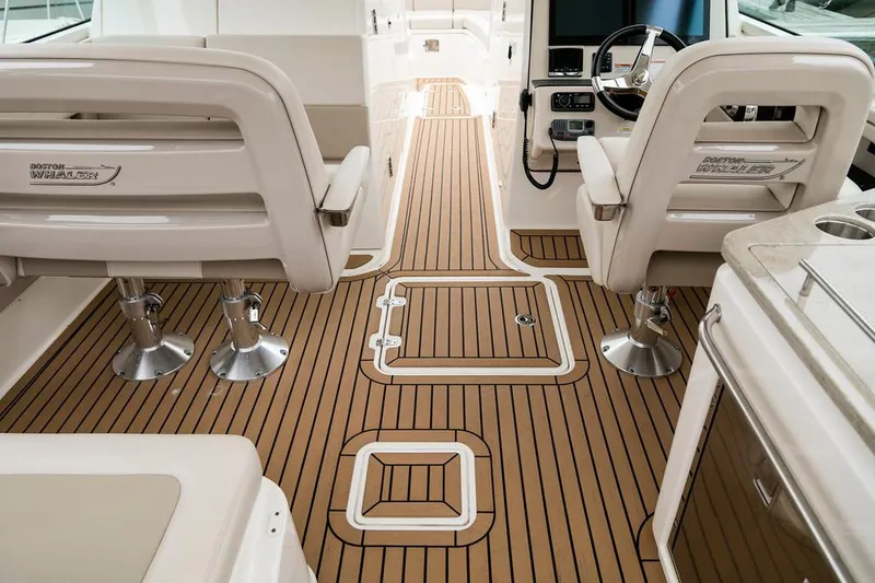 Manufacturer Provided Image: 2018 Boston Whaler 320 Vantage interior with teak flooring and dual captain chairs.