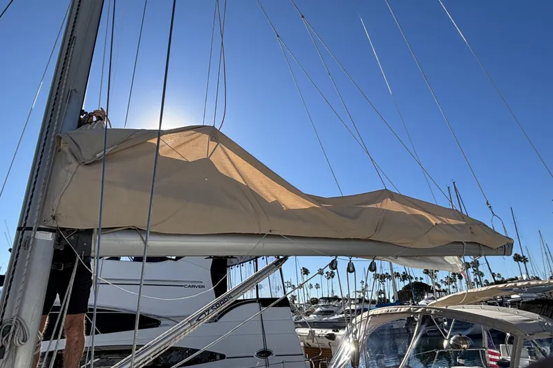 1997 Beneteau Oceanis 400 sailboat with covered mainsail in a sunny marina.