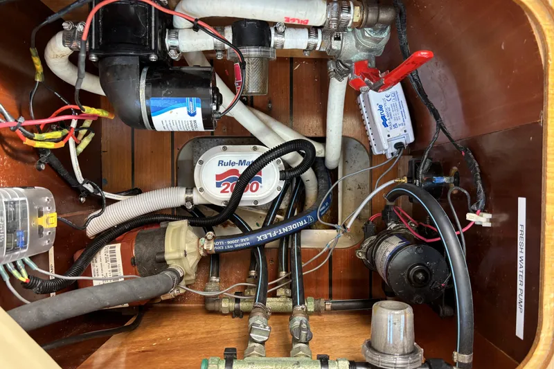Electrical and plumbing system inside a 1997 Beneteau Oceanis 400 sailboat.