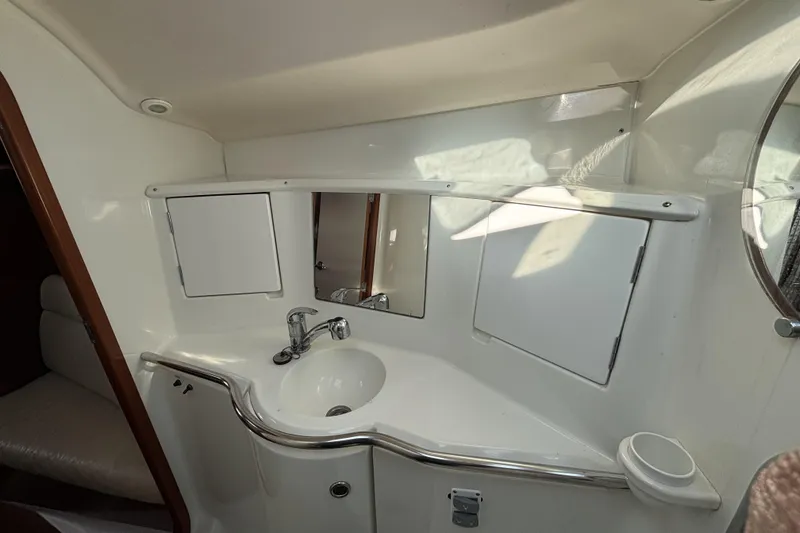 Interior view of 1997 Beneteau Oceanis 400 yacht bathroom with sink and mirror.
