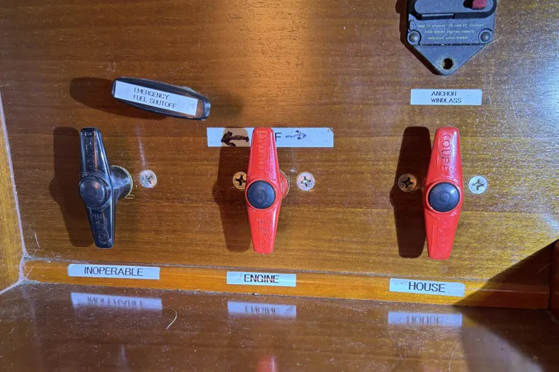Control panel of a 1997 Beneteau Oceanis 400 with labeled switches and emergency fuel shutoff.