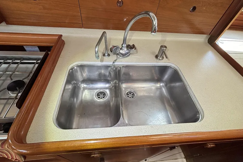 Stainless steel double sink in 1997 Beneteau Oceanis 400 yacht kitchen.