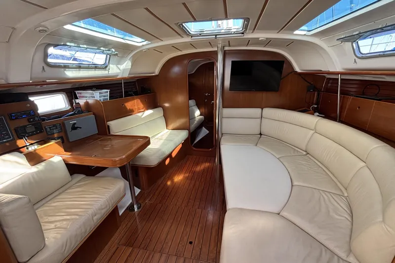 Interior of 1997 Beneteau Oceanis 400 yacht with elegant seating and wooden finishes.