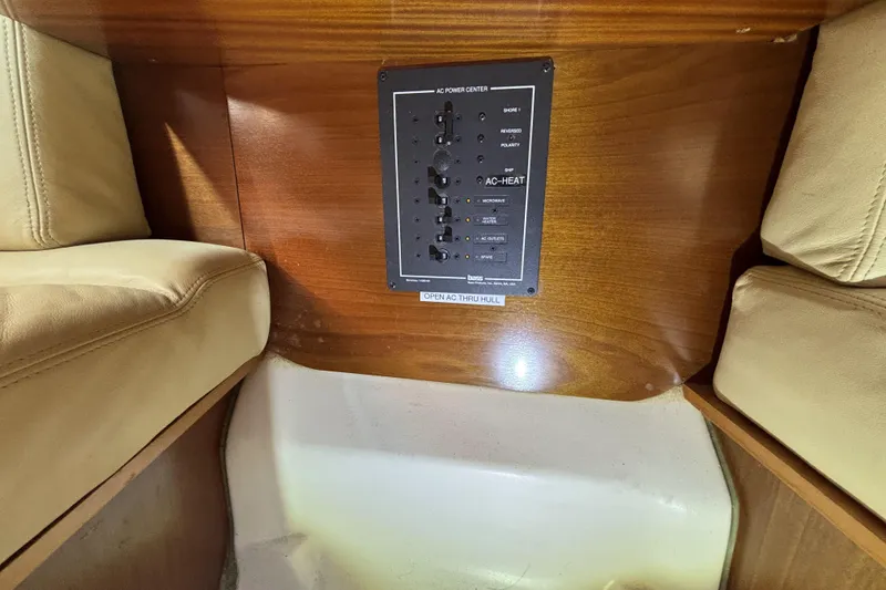 Control panel on a 1997 Beneteau Oceanis 400 yacht interior with beige seating.