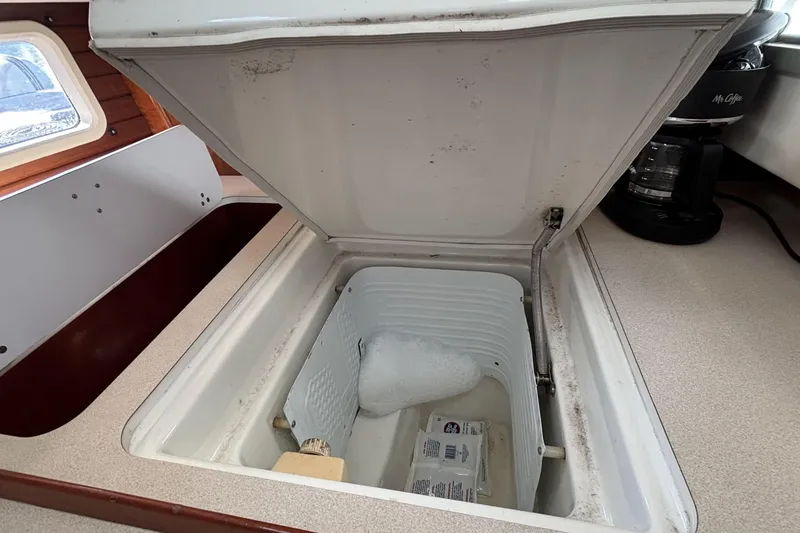 Open icebox in 1997 Beneteau Oceanis 400 yacht galley, showing interior storage space.