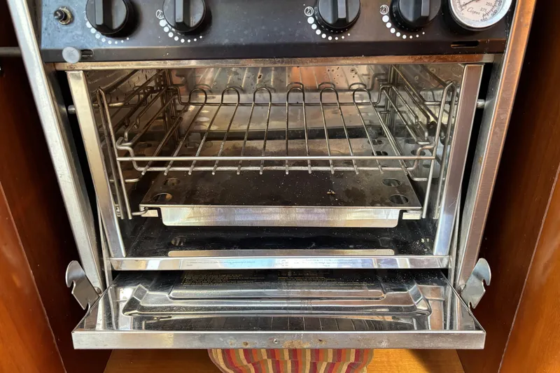 Stainless steel oven inside a 1997 Beneteau Oceanis 400 sailboat galley.