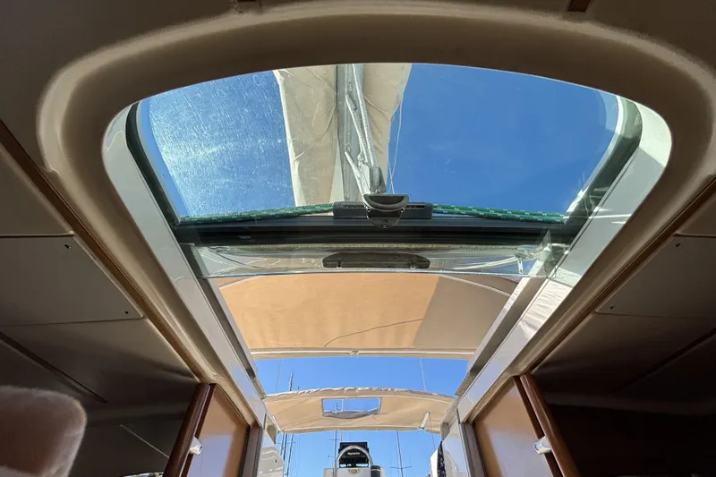 Interior view of 1997 Beneteau Oceanis 400 sailboat with open hatch and clear sky.