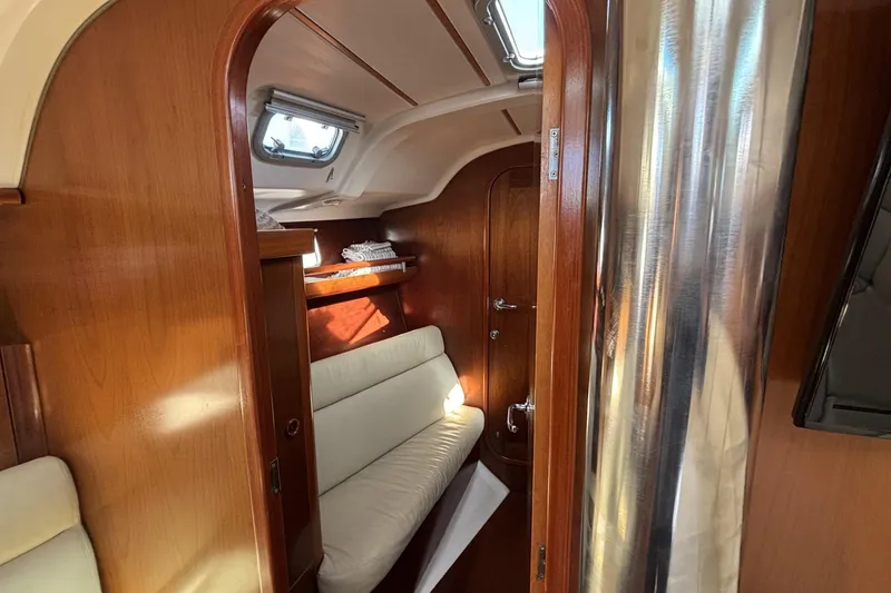 Interior of 1997 Beneteau Oceanis 400 sailboat with wooden finish and cozy seating.
