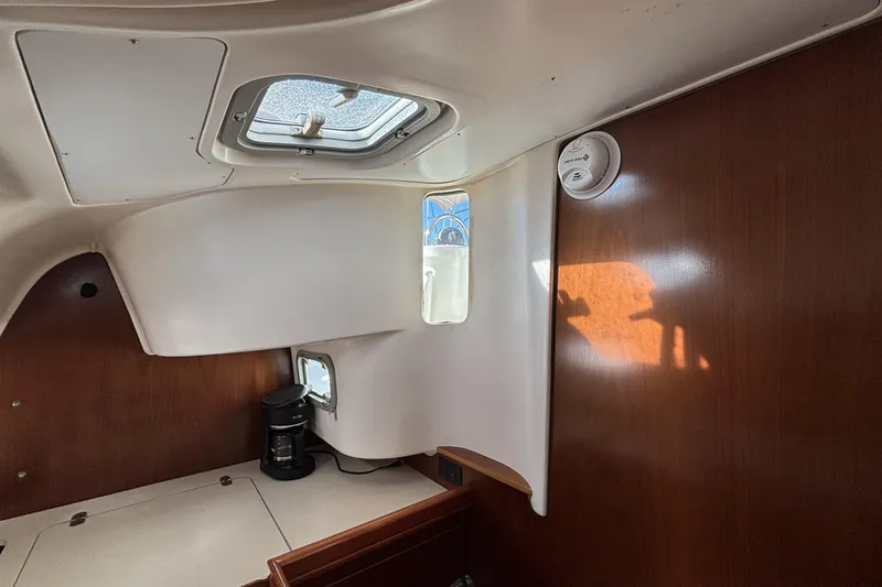 Interior of 1997 Beneteau Oceanis 400 sailboat with wood paneling and ceiling hatch.