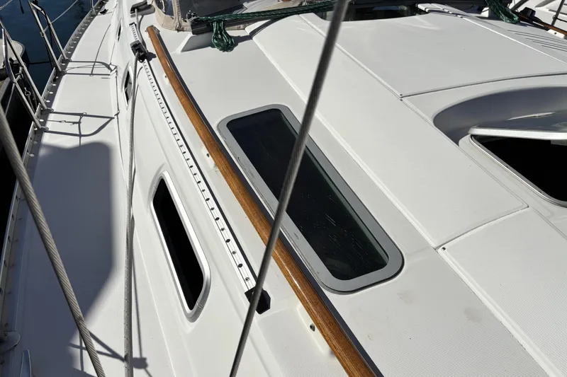 Deck view of 1997 Beneteau Oceanis 400 sailboat with sleek design and wooden accents.