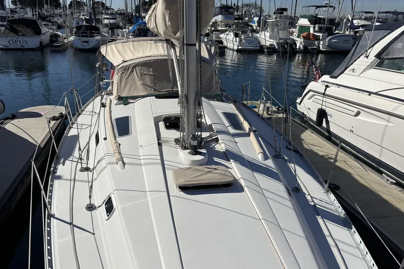 1997 Beneteau Oceanis 400 sailboat docked in a marina, surrounded by other boats.