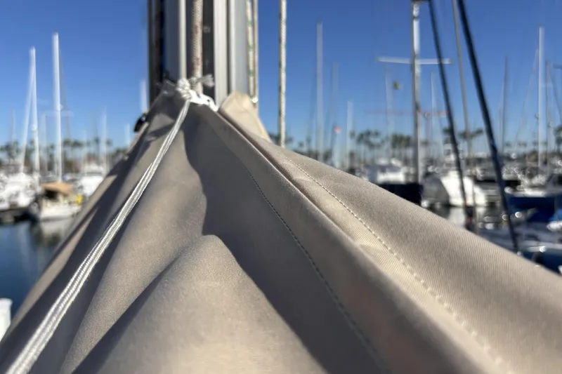Close-up of a sail on a 1997 Beneteau Oceanis 400 yacht in a marina.