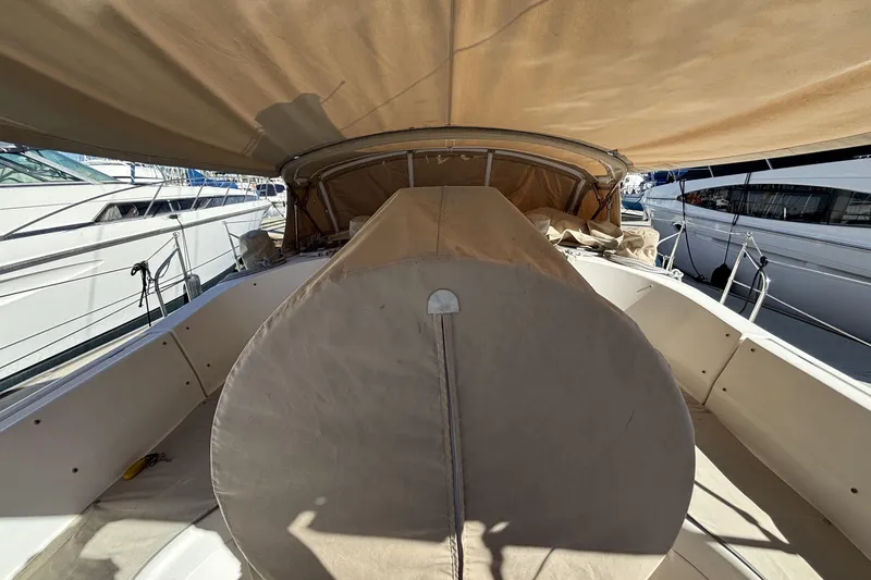 1997 Beneteau Oceanis 400 sailboat cockpit with beige canvas cover, docked at marina.