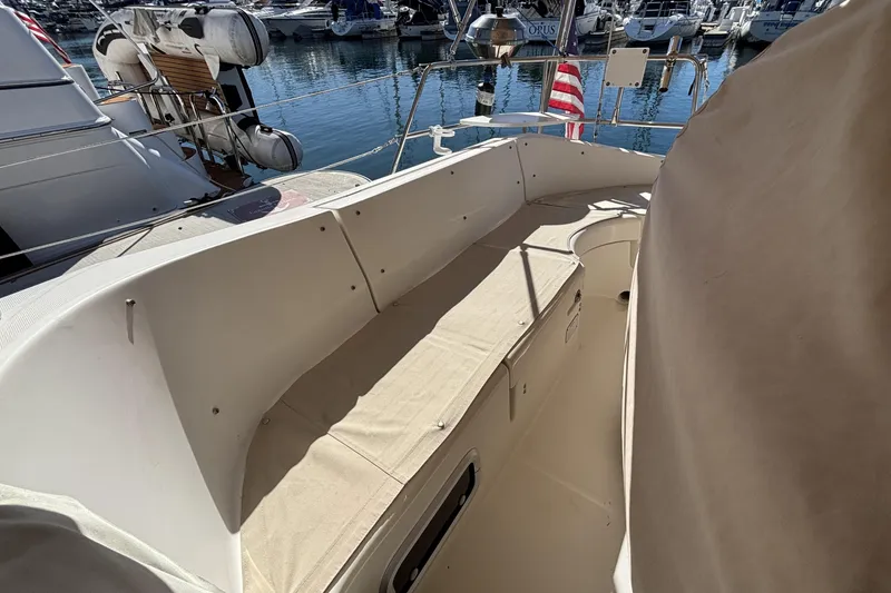 1997 Beneteau Oceanis 400 sailboat cockpit with beige seating, docked at marina.