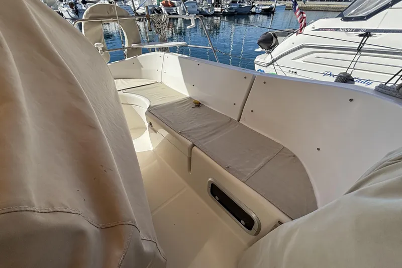 1997 Beneteau Oceanis 400 sailboat cockpit with beige seating, docked in marina.