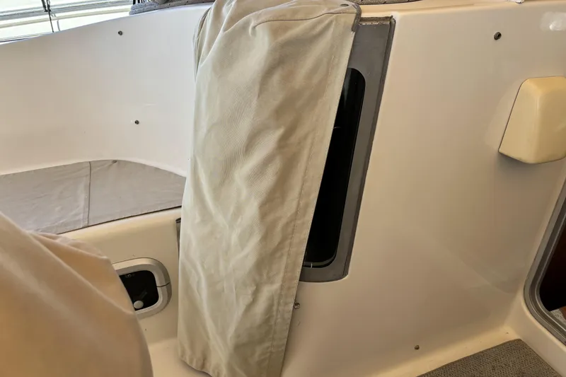 Interior view of a 1997 Beneteau Oceanis 400 sailboat with beige fabric cover.