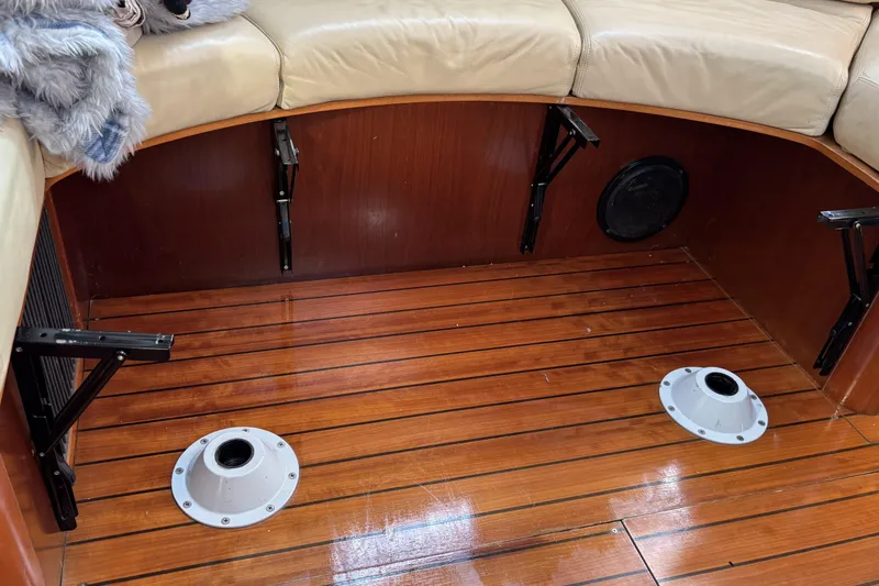 Interior of 1997 Beneteau Oceanis 400 yacht with wooden flooring and beige seating.
