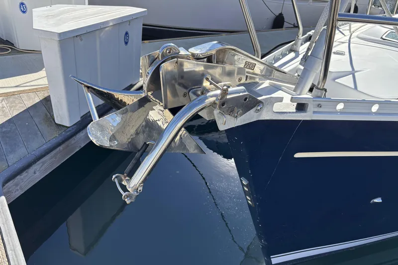 Bow of 1997 Beneteau Oceanis 400 with anchor, docked at marina.