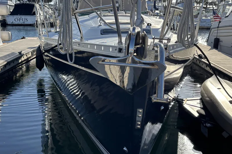 1997 Beneteau Oceanis 400 sailboat docked in marina, reflecting on water.