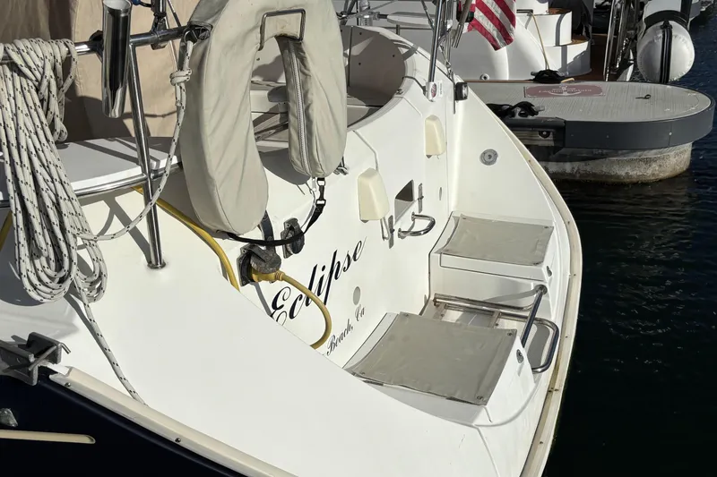 1997 Beneteau Oceanis 400 sailboat stern with lifebuoy and docked at marina.