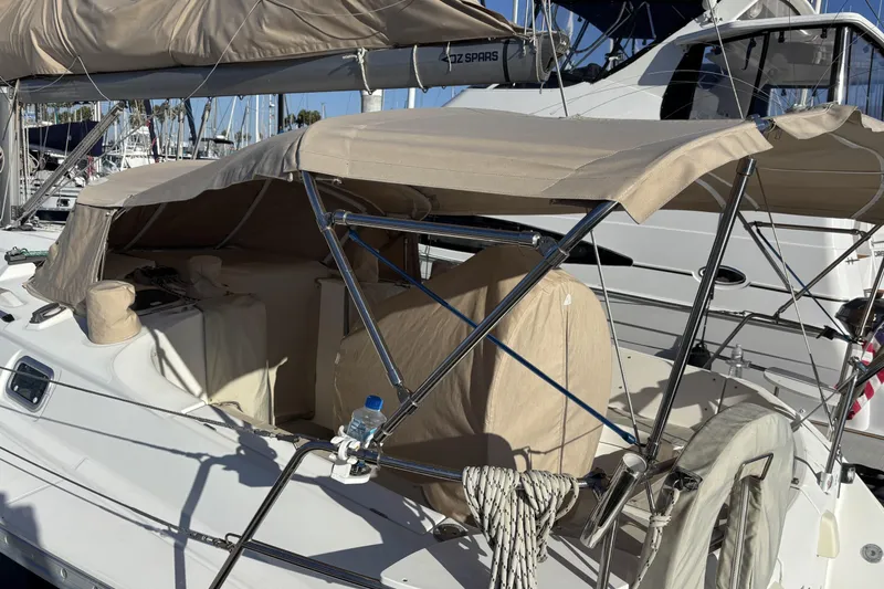 1997 Beneteau Oceanis 400 sailboat with beige canopy docked at marina.
