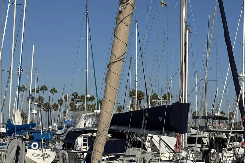1997 Beneteau Oceanis 400 sailboat docked in a marina with palm trees.