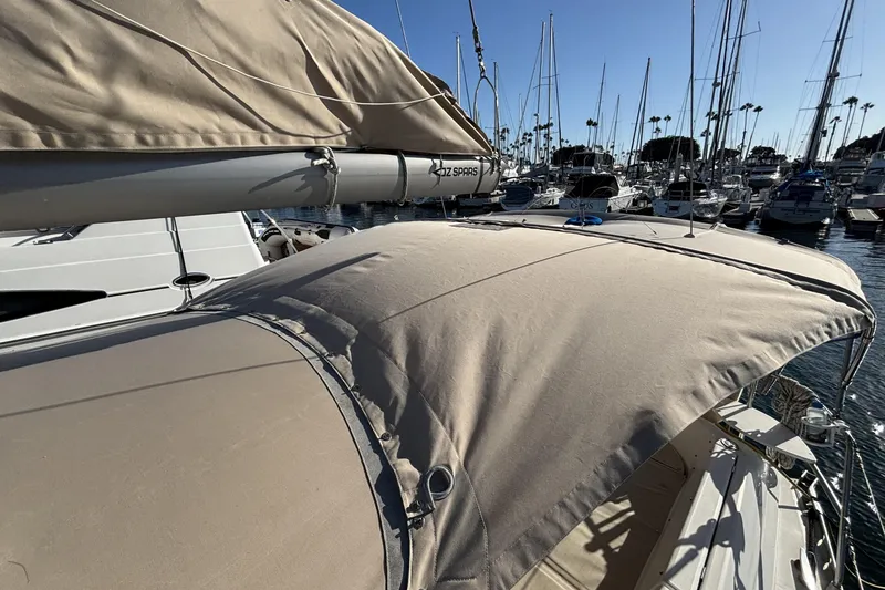 Beneteau Oceanis 400 sailboat, 1997 model, docked in a marina with beige canopy.