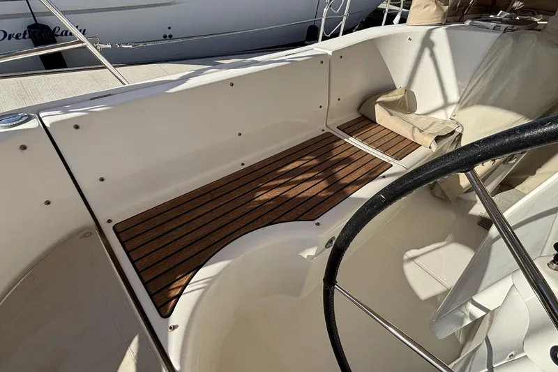 1997 Beneteau Oceanis 400 cockpit with wooden flooring and steering wheel.