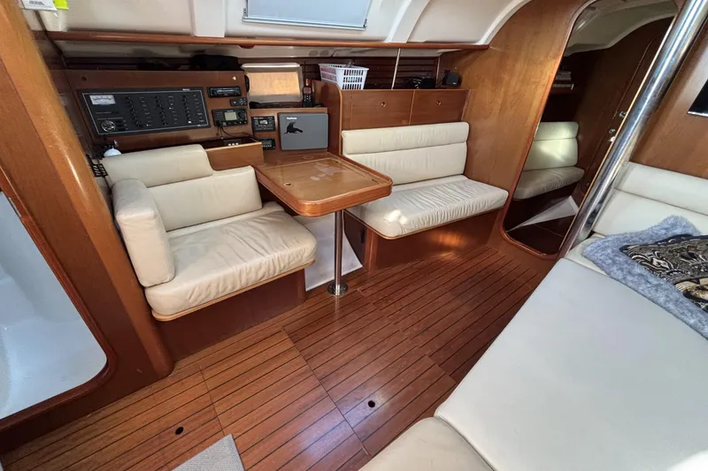 Interior of 1997 Beneteau Oceanis 400 yacht with wood paneling and cream seating.