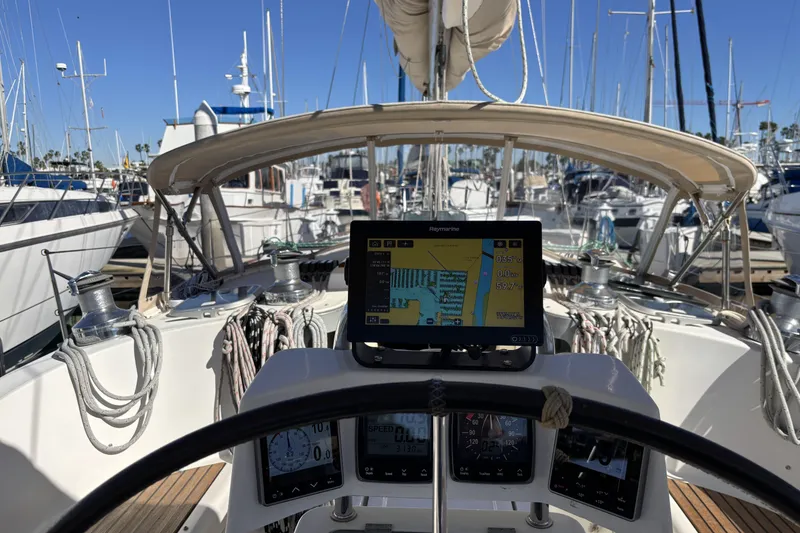 Cockpit view of a 1997 Beneteau Oceanis 400 sailboat with navigation equipment.