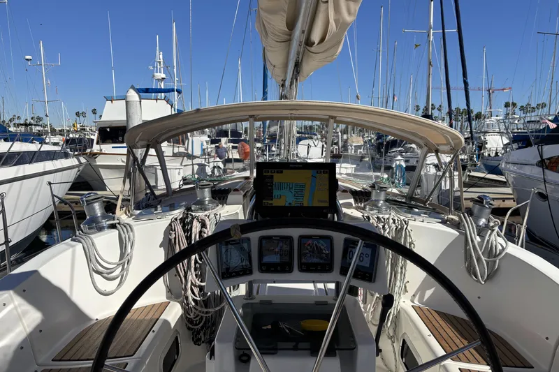 Cockpit view of a 1997 Beneteau Oceanis 400 sailboat docked in a marina.