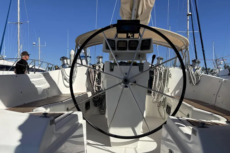 1997 Beneteau Oceanis 400 sailboat cockpit with steering wheel and navigation instruments.