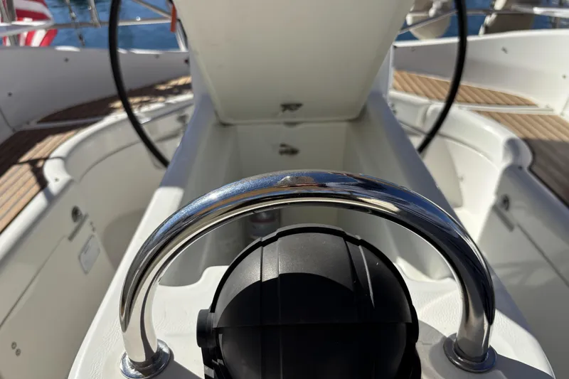 Cockpit view of 1997 Beneteau Oceanis 400 sailboat with steering wheel and open hatch.