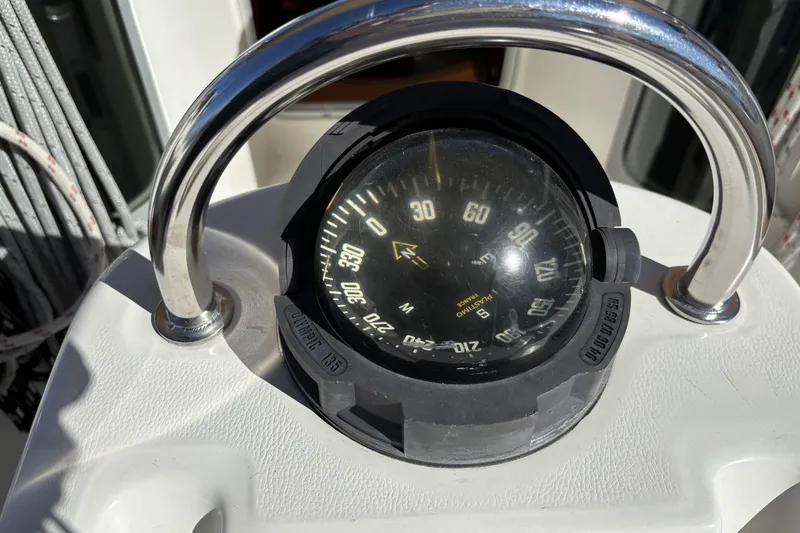 Compass on 1997 Beneteau Oceanis 400 sailboat, surrounded by stainless steel guard.
