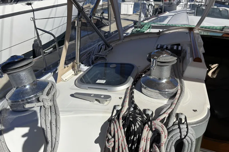 Deck of 1997 Beneteau Oceanis 400 sailboat with winches and ropes.