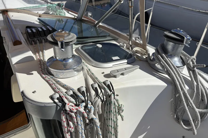 Deck of 1997 Beneteau Oceanis 400 sailboat with winches and ropes.