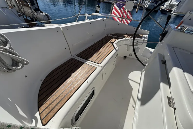 Cockpit of 1997 Beneteau Oceanis 400 sailboat with wooden seating and steering wheel.
