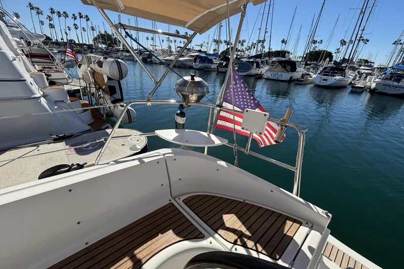 1997 Beneteau Oceanis 400 sailboat docked in marina with American flag.