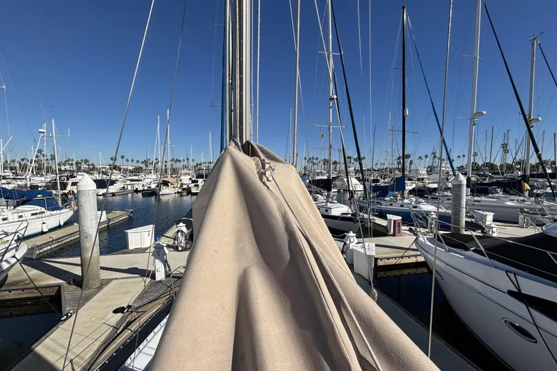 1997 Beneteau Oceanis 400 sailboat docked in a marina, surrounded by other boats.