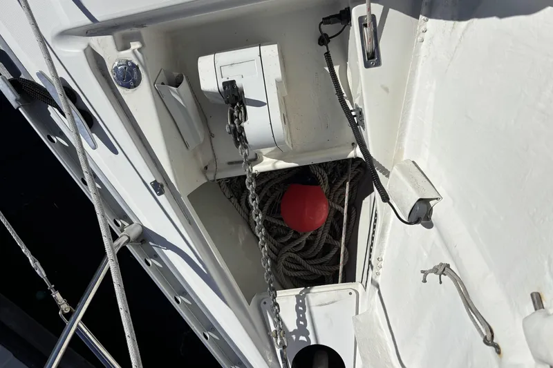Anchor locker of 1997 Beneteau Oceanis 400 with ropes and red buoy.