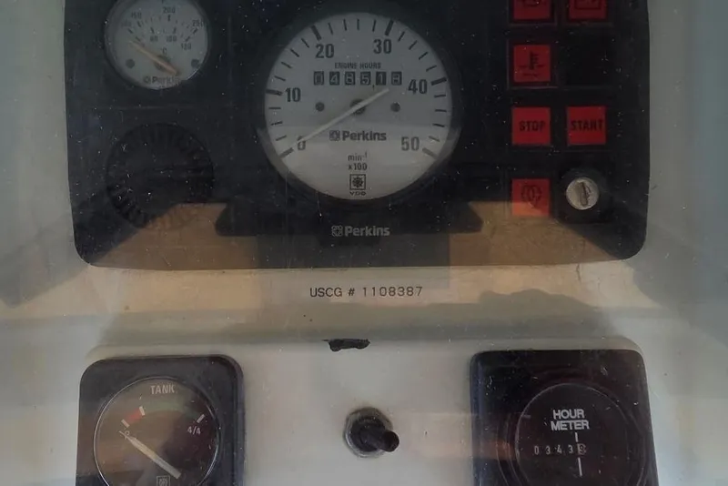 Control panel of a 1997 Beneteau Oceanis 400 sailboat with engine gauges and hour meter.