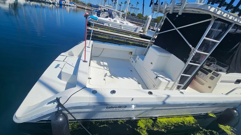 1992 Luhrs Tournament 300 boat docked in marina, featuring spacious deck and sleek design.