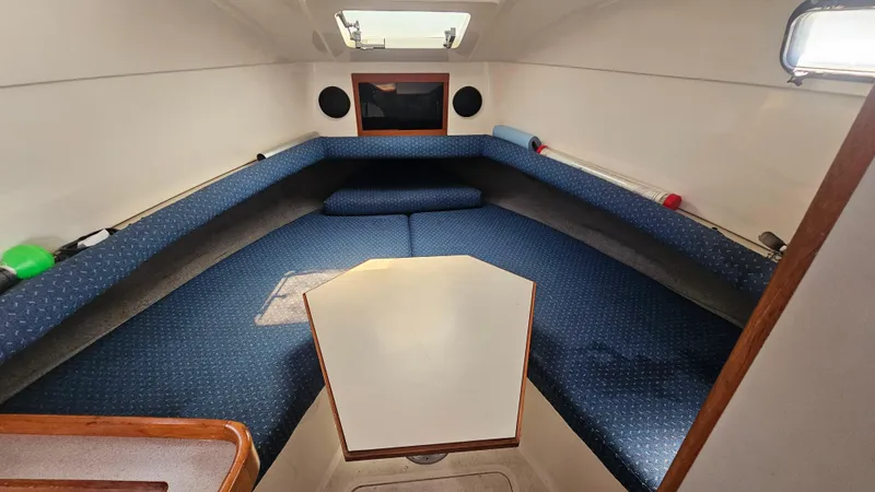 1992 Luhrs Tournament 300 cabin interior with blue seating and overhead hatch.