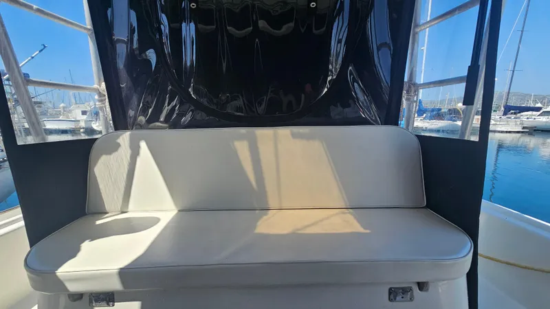 1992 Luhrs Tournament 300 boat interior with cushioned seating and marina view.