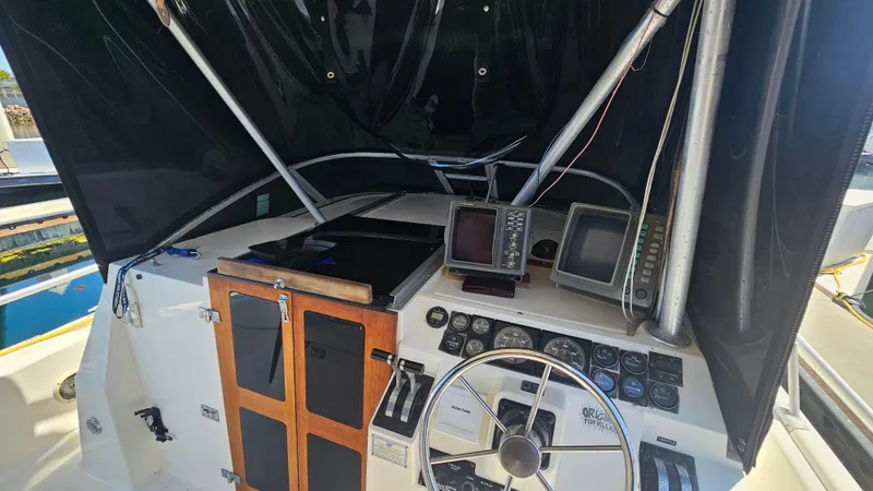 1992 Luhrs Tournament 300 boat cockpit with steering wheel and navigation equipment.