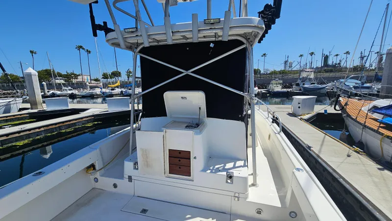 1992 Luhrs Tournament 300 boat docked at marina, featuring open deck and helm station.