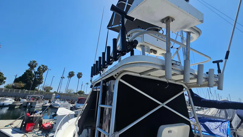 1992 Luhrs Tournament 300 boat docked at marina with clear blue sky.