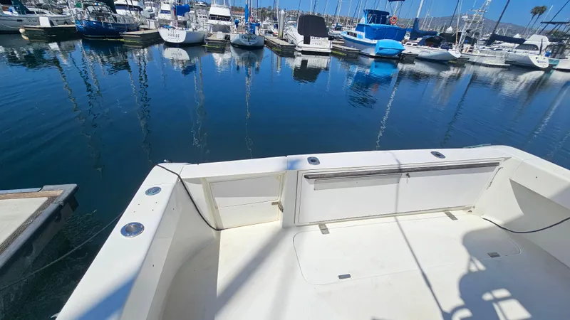 1992 Luhrs Tournament 300 boat docked in a marina with calm water and other boats.