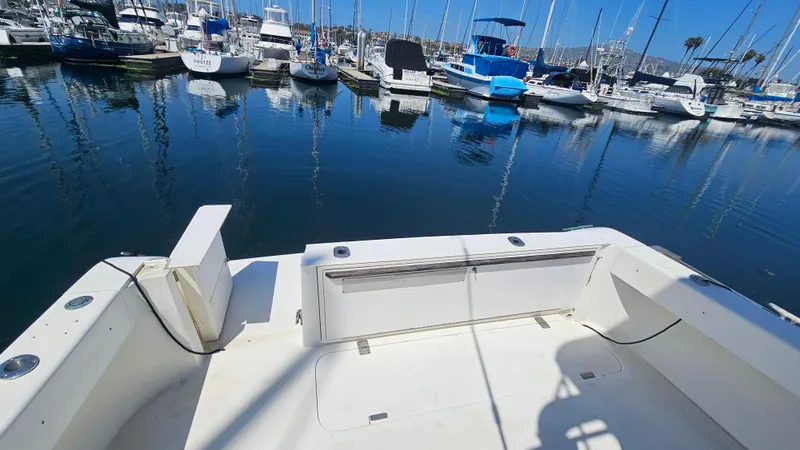 1992 Luhrs Tournament 300 boat docked in a marina with other vessels.