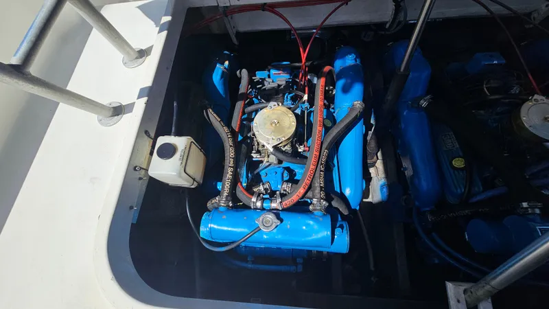 Engine compartment of a 1992 Luhrs Tournament 300 boat, featuring a blue marine engine.